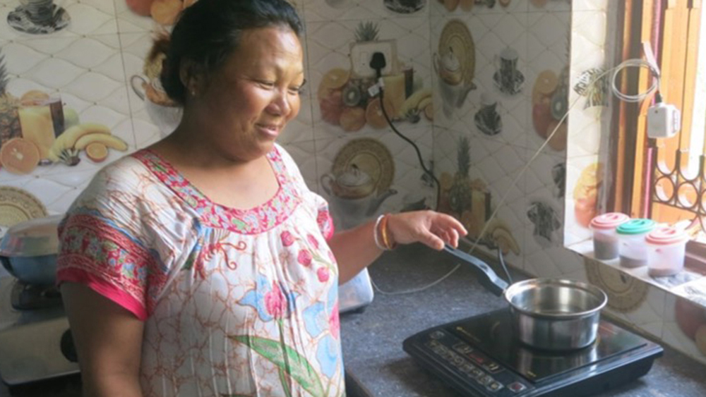 Woman cooking on electric stove